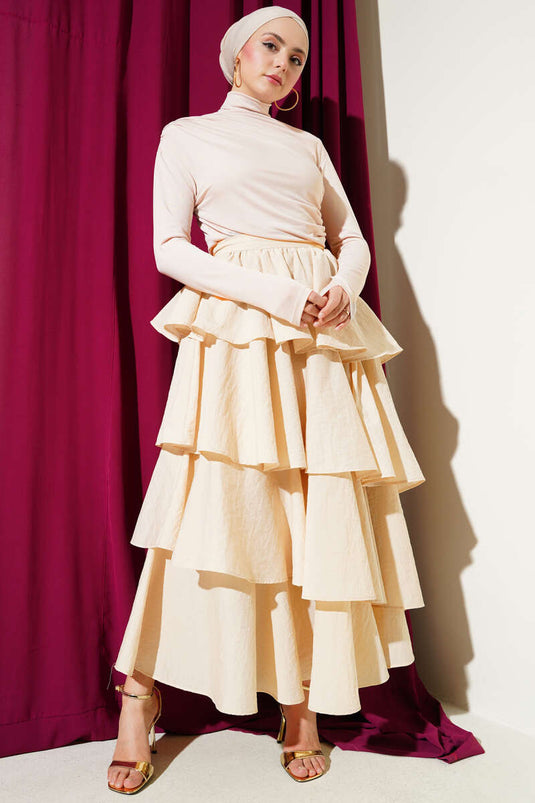 Chemisier beige sable à col roulé et fronces latérales