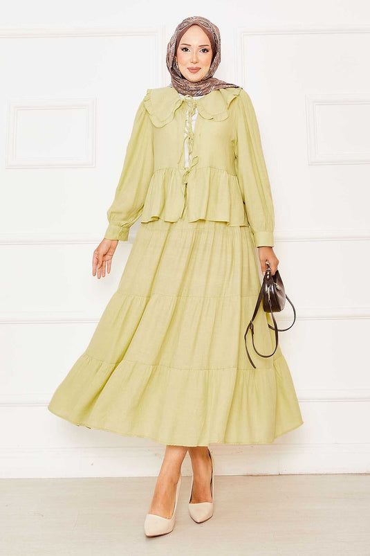 Combinaison bébé avec jupe nouée devant et col vert pétrole