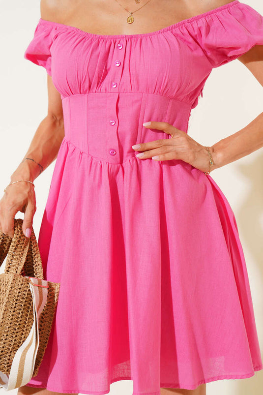 Fuchsia minijurk met taillecorset en knoopdetails.