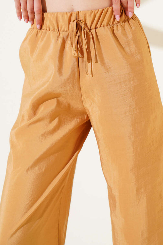 Elastischer Bund, weites Bein, glänzende Hose, Senfgelb