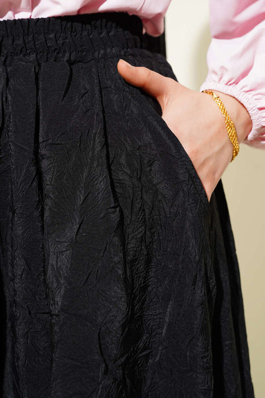 Jupe noire à poches plissée avec ceinture élastique