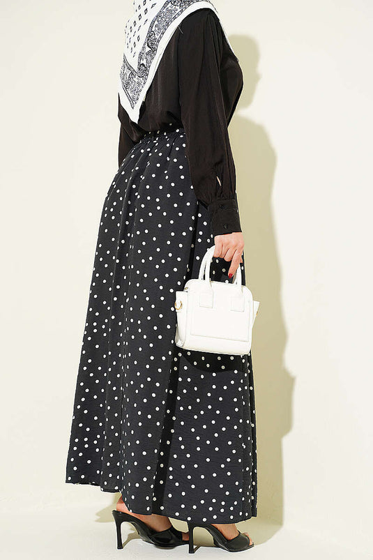 Jupe noire à pois avec ceinture élastique à la taille