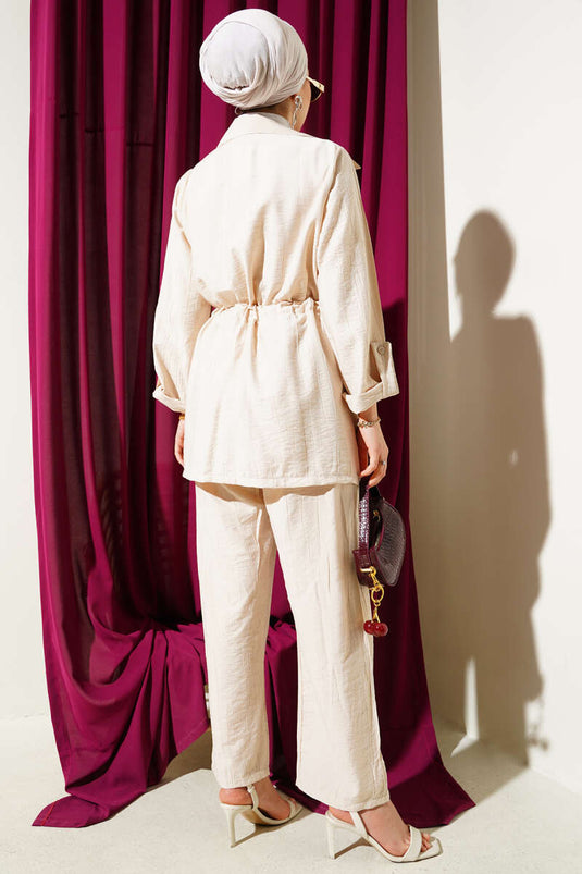 بدلة من قطعتين ذات صدر مزدوج وحزام خصر باللون البيج