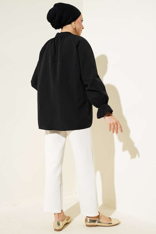 Tunique plissée noire à col élastique et cheville