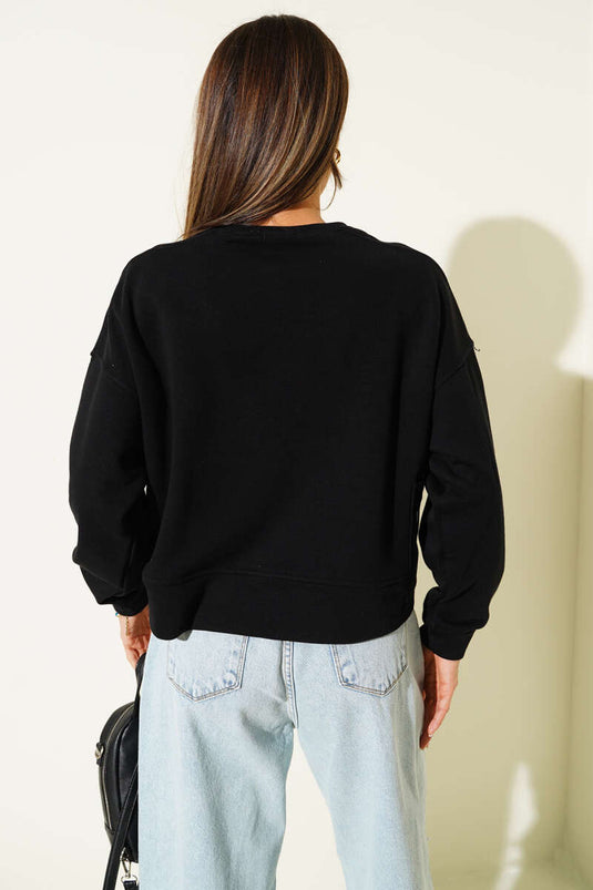 Zwarte sweater met zakdetails