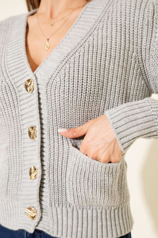 Cárdigan corto con dos bolsillos y patrón de punto acanalado, gris