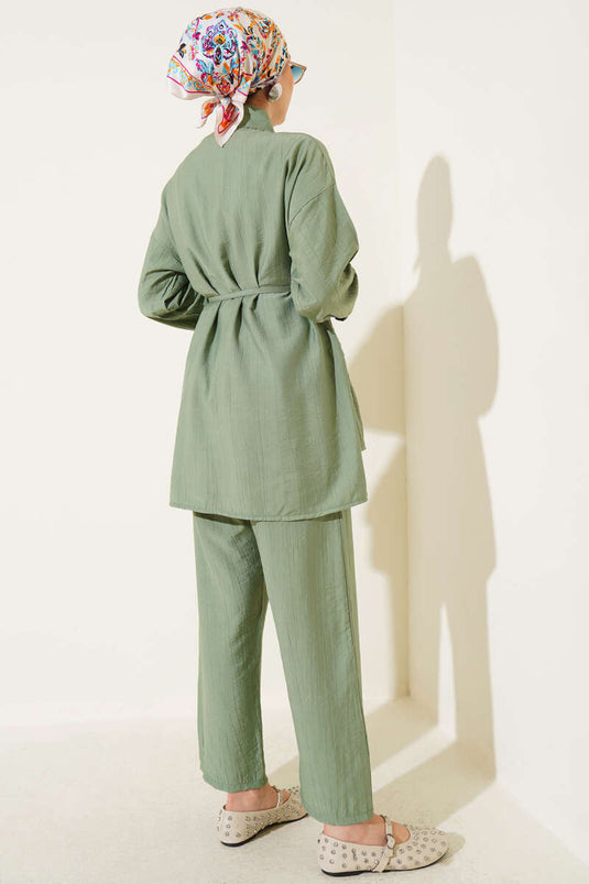 Two-piece set with ruffled skirt and drawstring belt, light green.