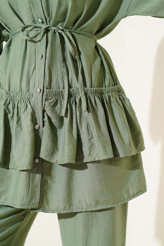 Two-piece set with ruffled skirt and drawstring belt, light green.