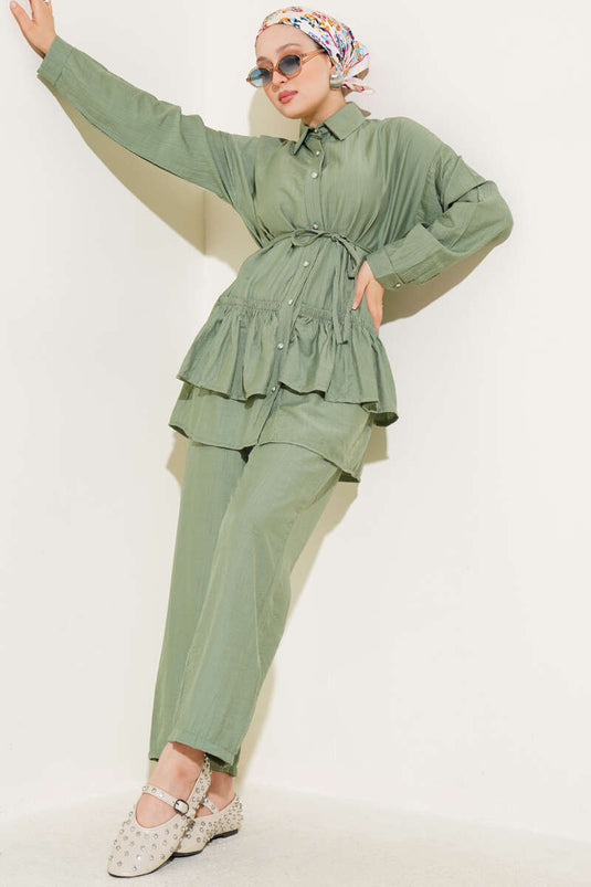 Two-piece set with ruffled skirt and drawstring belt, light green.