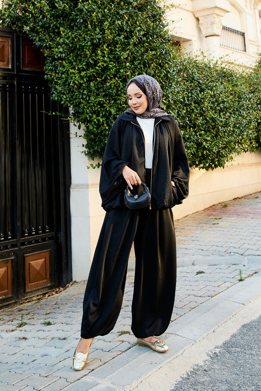بدلة سوداء فضفاضة من قطعتين بأكمام خفاش وسحاب