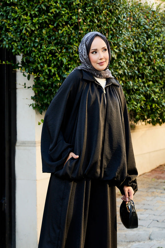 بدلة سوداء فضفاضة من قطعتين بأكمام خفاش وسحاب