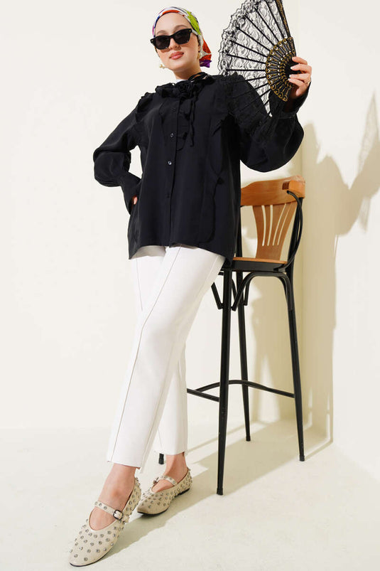 Camisa negra con accesorio de rosa con volantes