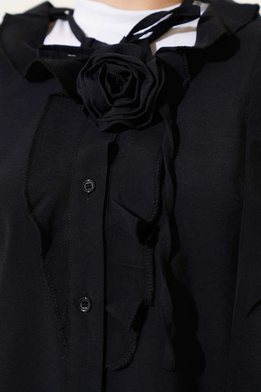 Camisa negra con accesorio de rosa con volantes