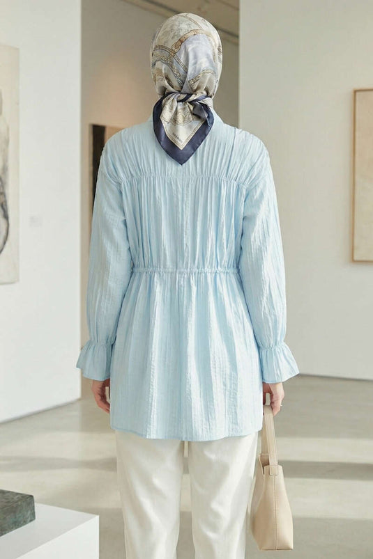 Chemisier bleu à manches élastiquées avec nœud