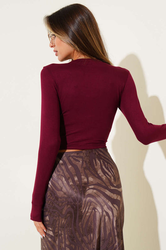 Long-sleeved crop top with bow detail, burgundy.