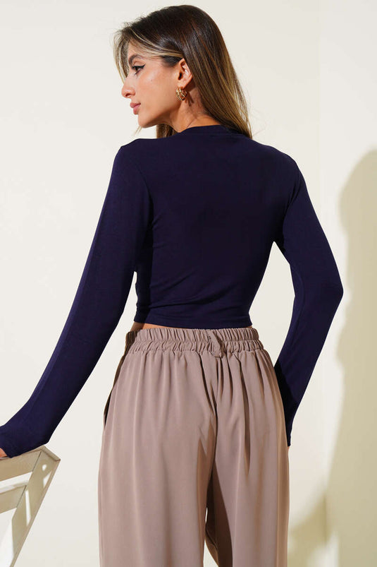 Long-sleeved crop top with bow detail, navy blue.