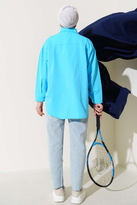 قميص أساسي بأزرار مخفية باللون الأزرق