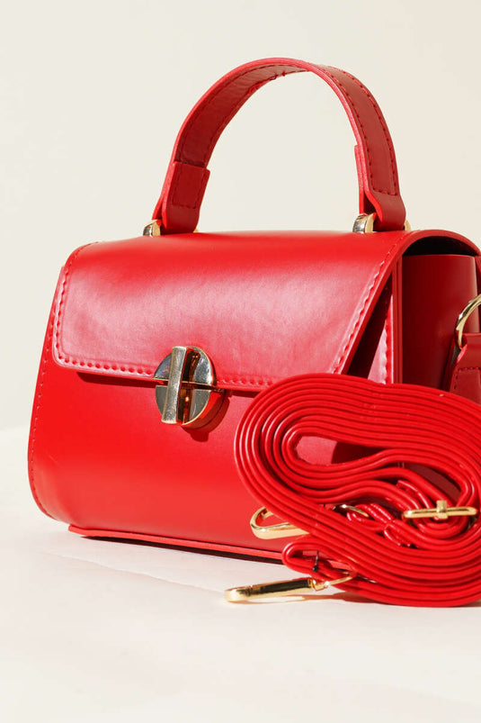 Sac rouge à fermeture éclair dorée