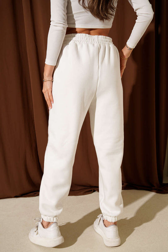 بنطال مطرز بثلاثة خيوط بشعار الهوكي، لون بيج فاتح