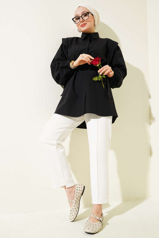 قميص أسود بأكمام طويلة وحزام على الكتف