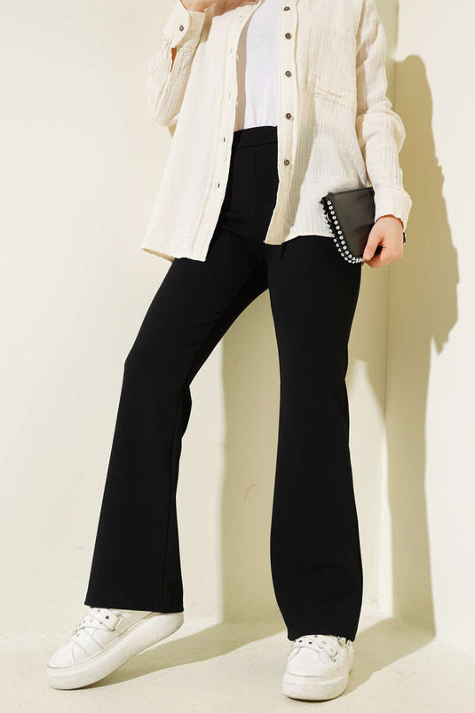 Pantalon noir à taille élastique et jambes espagnoles