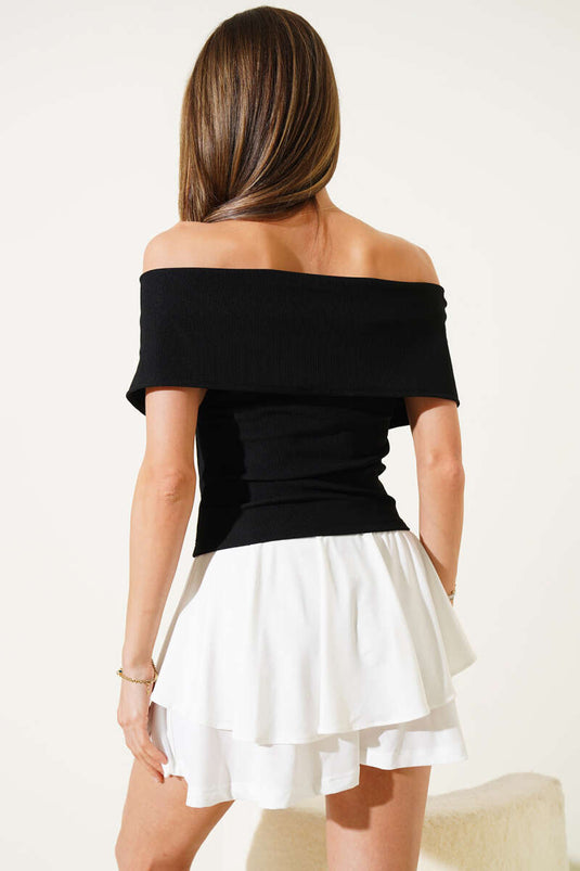 Blouse noire à col bateau et fermeture éclair