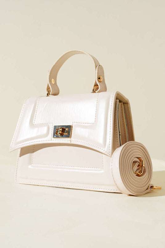 Cream-colored bag with lock detail and edge stitching.