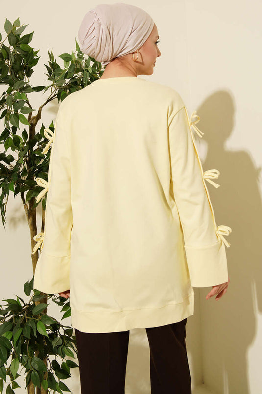 تونيك أصفر بتفاصيل فيونكة على الأكمام