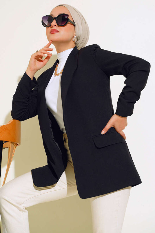 سترة بأكمام مكشكشة باللون الأسود