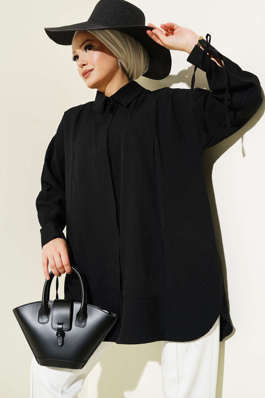 Chemise noire à poignets plissés et poignets boutonnés