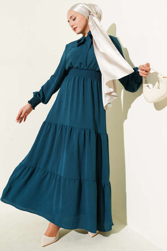 Jurk met strikdetail aan de voorkant en elastische tailleband, petrolgroen