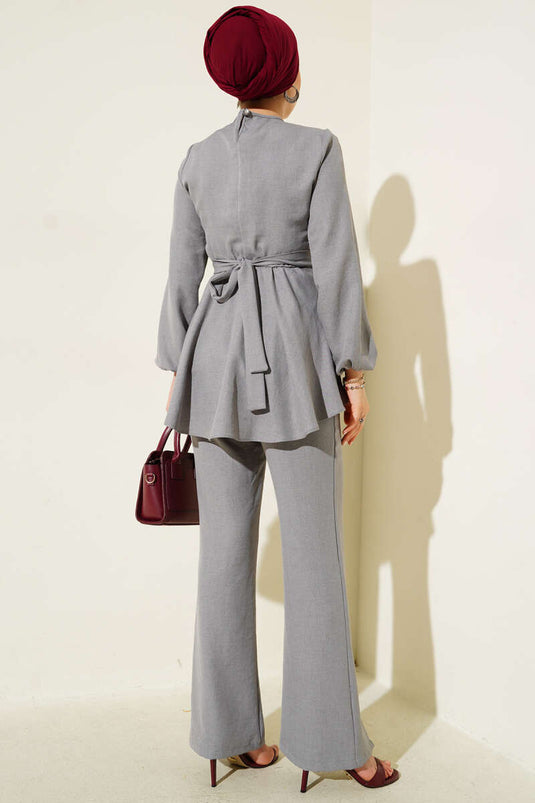 طقم من قطعتين باللون الرمادي مع حزام أمامي متقاطع