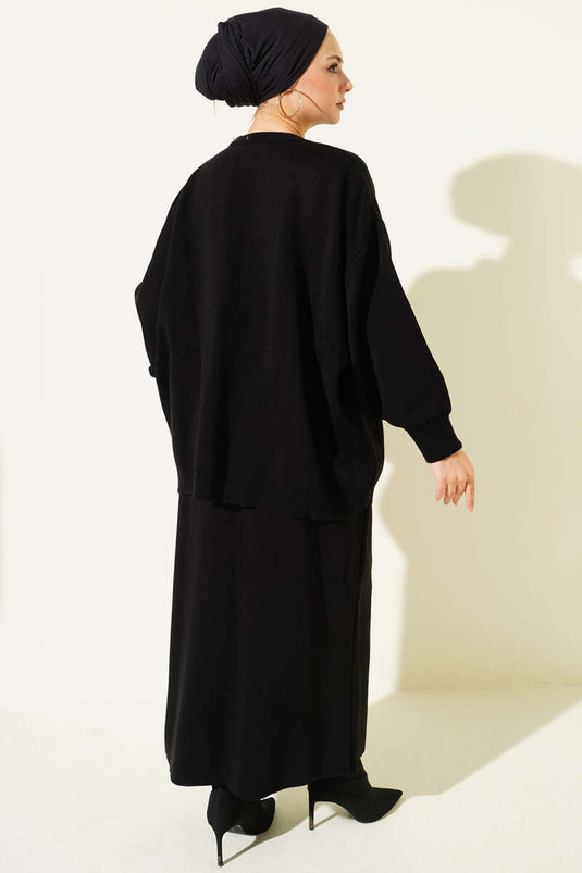 Ensemble deux pièces en maille noire : tunique oversize et jupe.