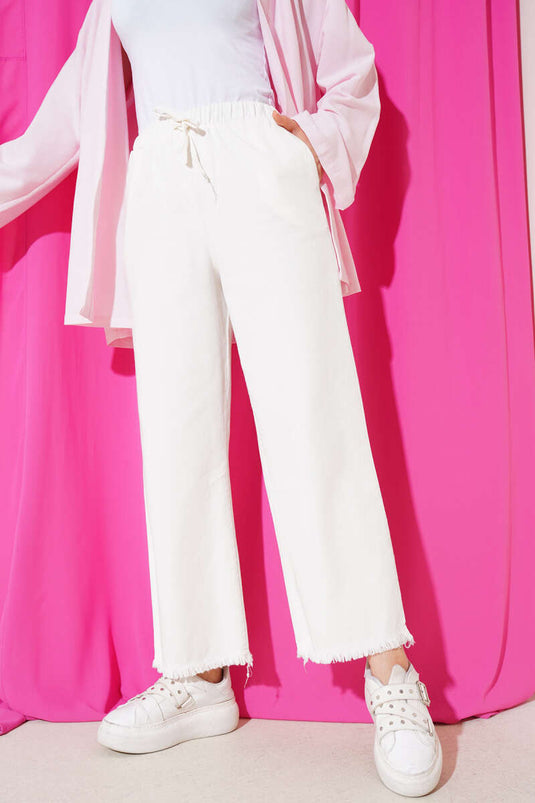 Weiße Hose mit Quasten und Spitzendetails