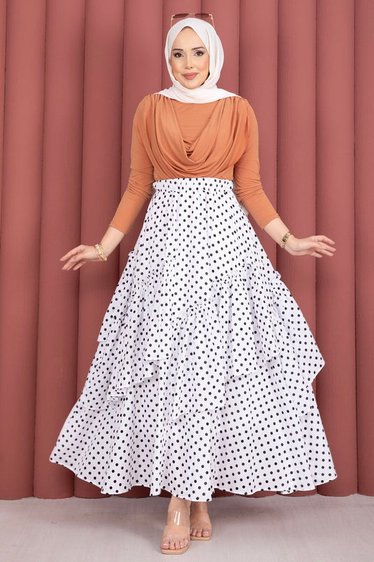 Jupe blanche à pois avec découpe asymétrique et empiècements