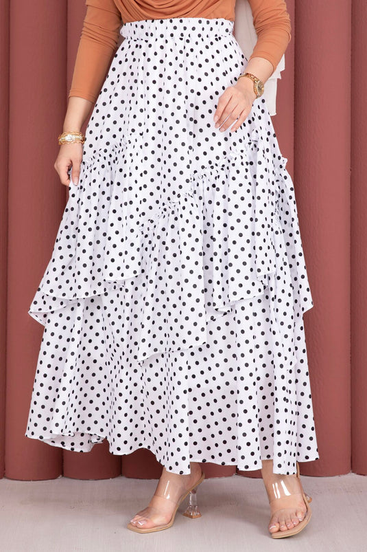 Jupe blanche à pois avec découpe asymétrique et empiècements