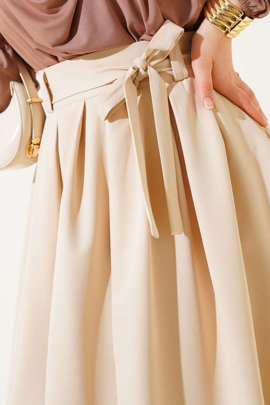 Pileli Kuşaklı Kloş Etek Bej