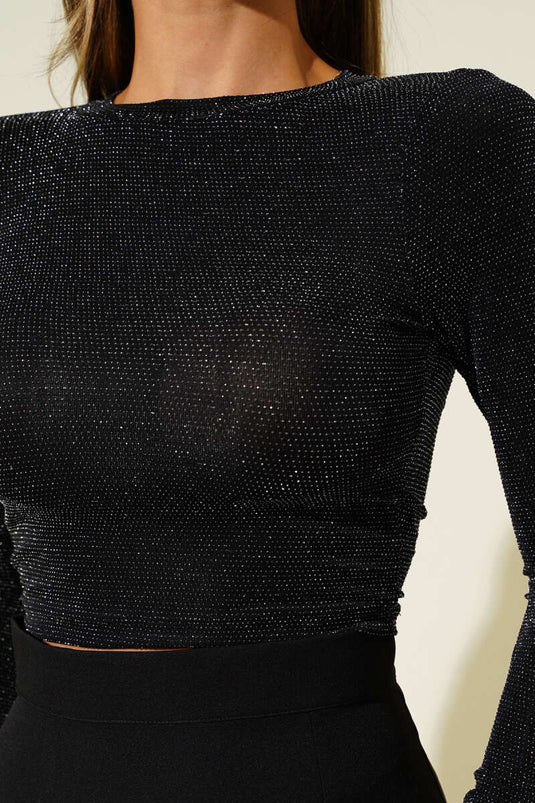 Schwarze, glitzernde Bluse mit rückenfreiem Detail