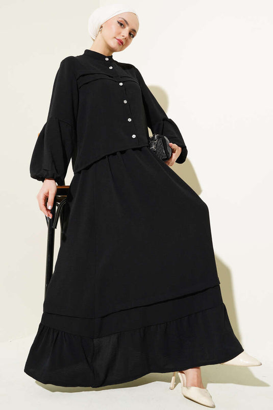 Abito due pezzi con gonna a balze e bottoni in pietra, nero