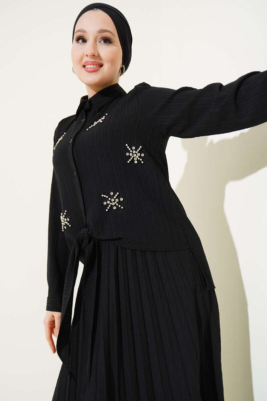 Costume deux pièces noir à jupe nouée devant et à lanières