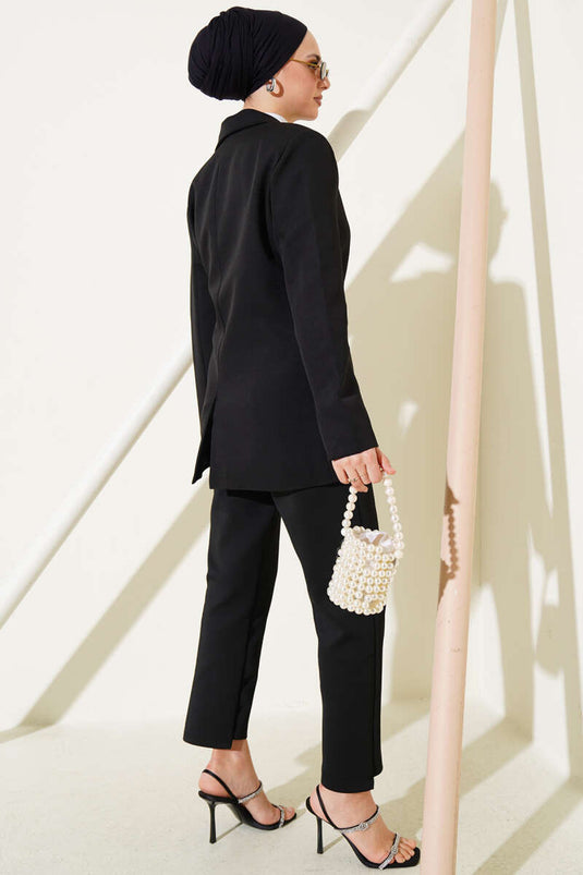 Veste noire à double boutonnage et fermeture latérale