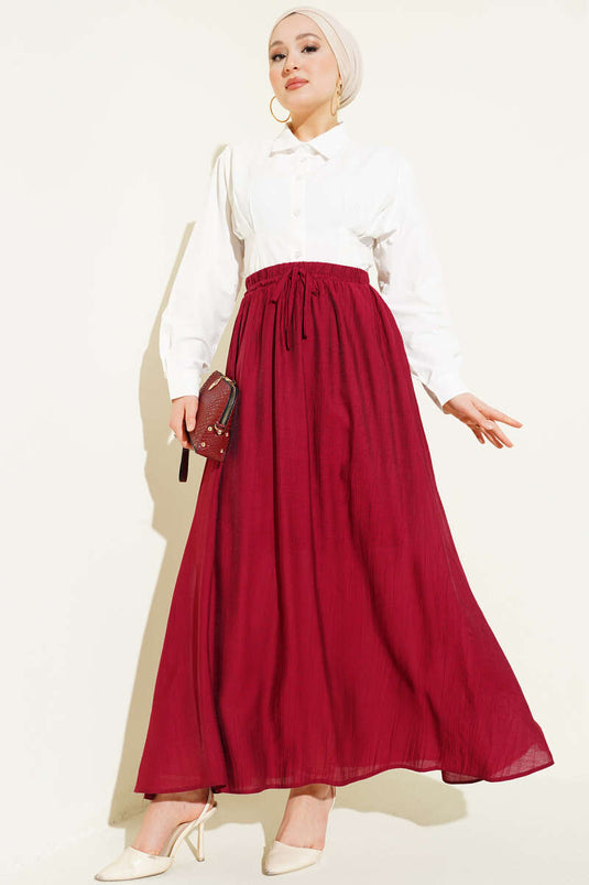 تنورة واسعة بتفاصيل جيب جانبي باللون القرمزي