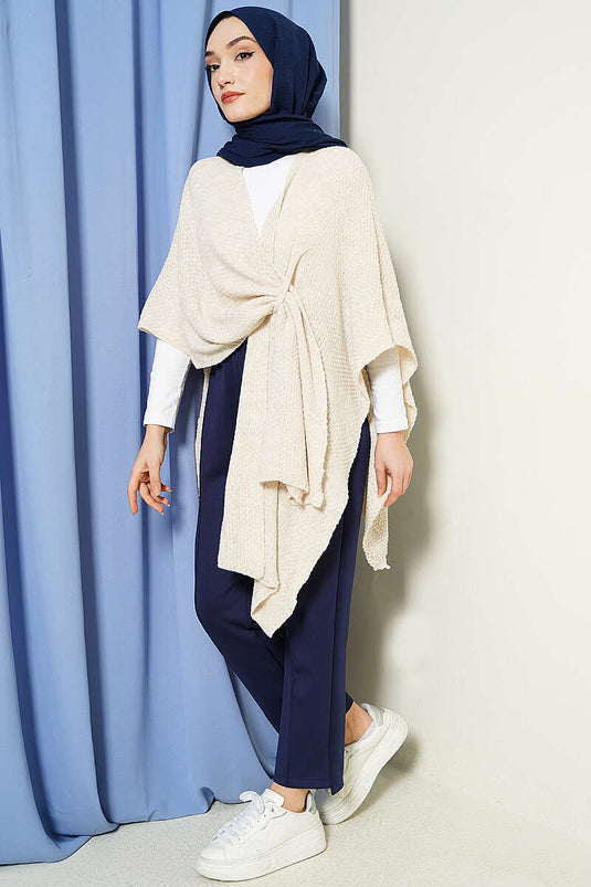 Poncho in maglia con taglio asimmetrico e pietre