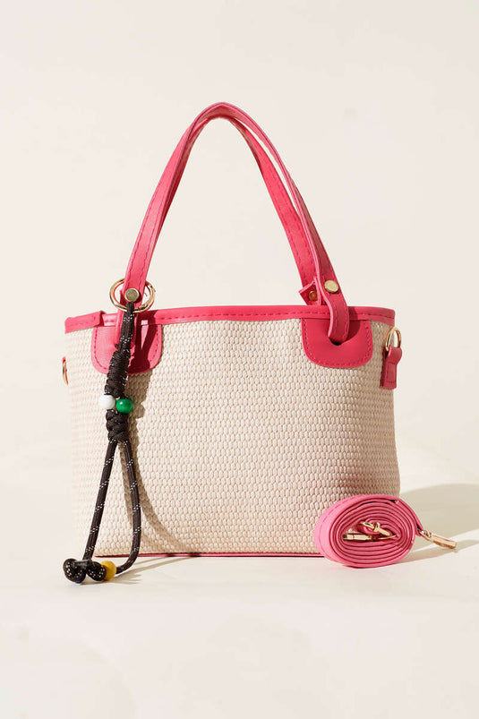 Borsa di paglia rosa con dettagli in pizzo