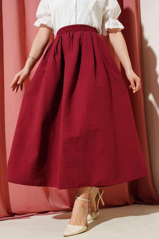 Jupe évasée bordeaux avec poches et ceinture élastique