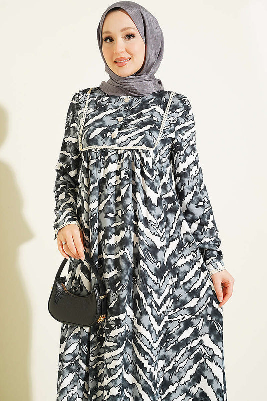 Schwarzes Langarmkleid Mit Spitzenmuster An Brust Und Taille