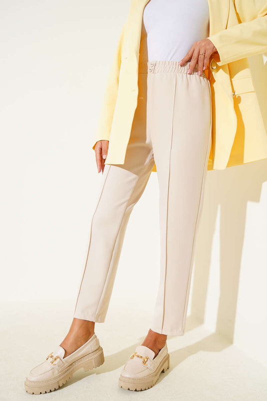 بنطلون ضيق بحزام خصر مطاطي باللون البيج