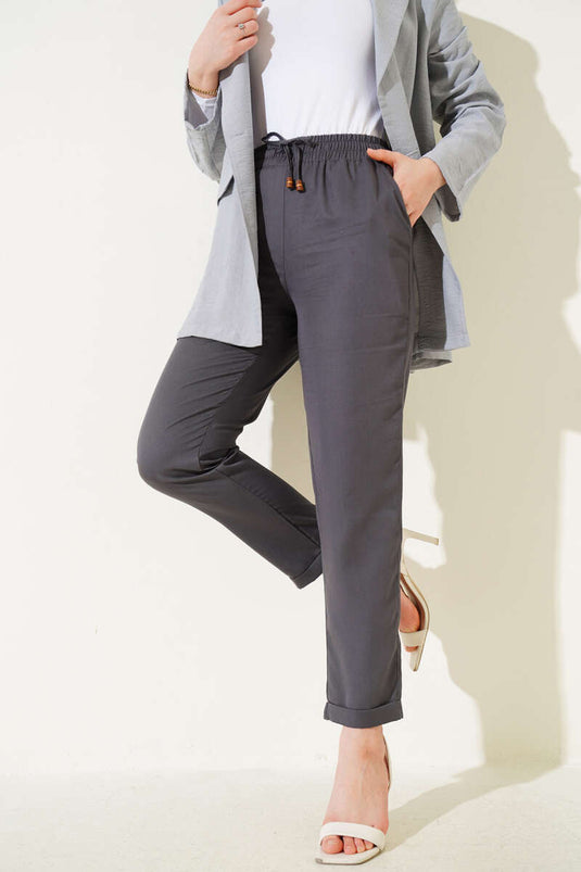 Pantalon à taille élastique en tissu gris foncé avec des jambes larges