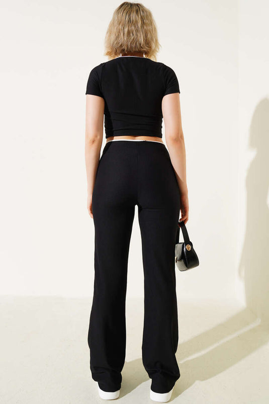 Schwarzer zweiteiliger Anzug mit Schleife und Crop-Top