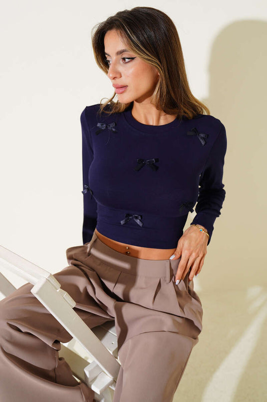 Long-sleeved crop top with bow detail, navy blue.